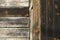 Detail of old unpainted wooden door with horizontal and vertical slats and.