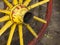 Detail of old wagon wheel with metal rim in red