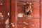 Detail of an old, weathered and rustic door with a rusty, Egyptian themed door knocker