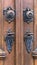 Detail of an old wooden door with bronze handles and locks