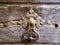 Detail of an old wooden farmhouse door with a metal knocker, Val d`Orcia, Tuscany, Italy