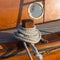 Detail of an old wooden sailing ship with rope and porthole