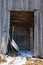 Detail of an old wooden shack in Switzerland with snow on the gr