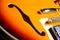 Detail of an Orange and yellow semihollow electric guitar