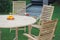 Detail of Outdoor furniture with armchairs and table in outdoor.Outdoor teak garden furniture set with round table and armchairs