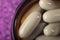 Detail Photo of Beige Pills On Purple Background