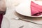 Detail photo of cutlery tableware on a table, fork, plate and napkin