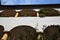 Detail, photographed from below, of a house with arcades and flower pots, inside a courtyard in Graz.