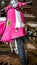 Detail of pink scooter with chromed metallic fender