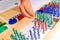 Detail of pins and beans on a montessori board to perform mathematical divisions