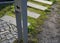 Detail of placement of dog excrement bags in a metal post symbol dog  pedal road made of concrete tiles and chipped granite around