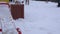 Detail of playground covered in snow and woman pull baby child in sledge. 4K