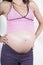 Detail of pregnant tummy pink shirt