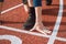 Detail of a professional athlete`s hand position at the start of a 100m sprint. Outdoor athletics oval