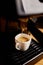 Detail of a professional coffe maker dripping coffe into an empty cup in a cafeteria