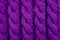 Detail of purple cable knitting stitch