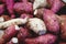 Detail of purple sweet potatoes and white root vegetables in a local market in Merida, Yucatan, Mexico