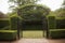 Detail of a quaint garden gate under a trellis