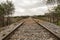 Detail of the rails of the tracks of a train that are lost in the infinity surrounded by boulders. Concept trains, tracks,