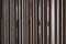Detail of Random wooden strip with stainless steel trim in mirror finished wall in vertical direction / interior design / detail d