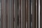 Detail of Random wooden strip with stainless steel trim in mirror finished wall in vertical direction / interior design / detail d