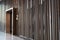 Detail of Random wooden strip with stainless steel trim in mirror finished wall in vertical direction / interior design / detail d