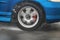 Detail of the rear wheel of a car driving in the rain