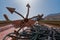 Detail of red anchor with black rope attached on a front of traditional arab dhow boat. Hot, sunny day with clear skies