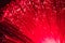 Detail of red growing bunch of optical fibers background, fast l