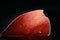 Detail of red leave with light on dark background. Closeup of portion of red leaf