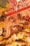 Detail of red metal rake and piles of bright yellow maple leaves in autumn