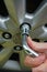 Detail of removing alloy wheel disc with telescopic lug wrench