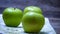 Detail on ripe green apples on wooden table