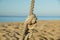 Detail of rope railing of beach walkway, old metal pole, seaside vacation, tranquility, relaxation,