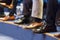 Detail of row of men`s formal corporate business shoes. Business people sitting at seminar.