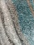 Detail Of A Rug In Teal, Gray And White Wavy Pattern