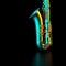 Detail of a saxophone on a black background