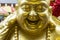 Detail of the sculpture of fat Buddha laughing