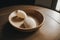 Detail of a seashell necklace on a wooden table