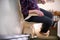 Detail Of Senior Woman Sitting On Stair Lift At Home To Help Mobility