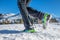 Detail of shoes in the snow with crampons during mountain walk in winter