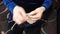 Detail shot of an elderly woman hands knitting woolen sock in traditional style