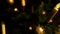 Detail shot glass ball on christmas tree and lit candles, night setting