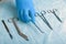 Detail shot of sterilized surgery instruments with a hand grabbing a tool ,