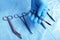 Detail shot of sterilized surgery instruments with a hand grabbing a tool ,