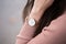 Detail shot of a young fashionable business woman with golden watch on hand