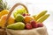 Detail from side on a basket full of fresh bio fruit on light background