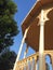 Detail side view of Ornate yellow wooden music pavillion in a park. Traditional Canarian music kiosk under blue sky. Gazebo or