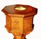 Detail on sides of antique wood baptism font with eight sides