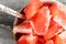 Detail on small porcelain bowl with spoon, full of pink grapefruit cut into pieces.